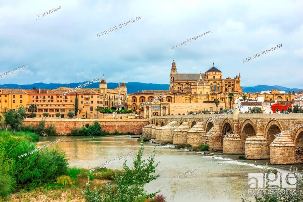 Stock Photo: Roman Bridge on Guadalquivir river and Mezquita Cathedral (Great Mosque) at dawn in the city of Cordoba, Andalusia, Spain.