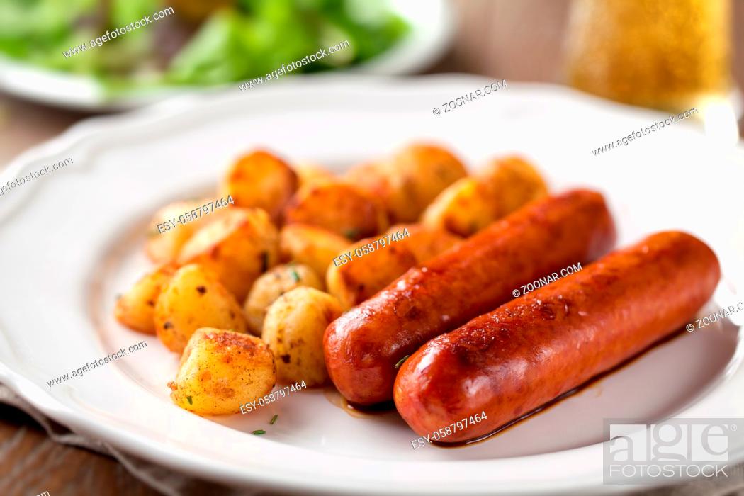 Stock Photo: Sausages and potatoes on a plate. High quality photo.