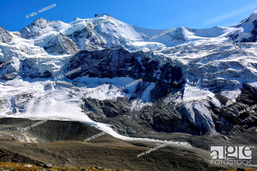 Stock Photo: The Zinalrothorn (centre), and the Pointe Sud du Moming (left) in the Swiss Alps above the mountain resort of Zinal.