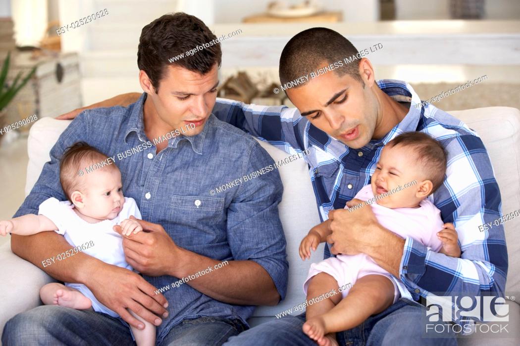 Stock Photo: Two Young Fathers On Sofa At Home.