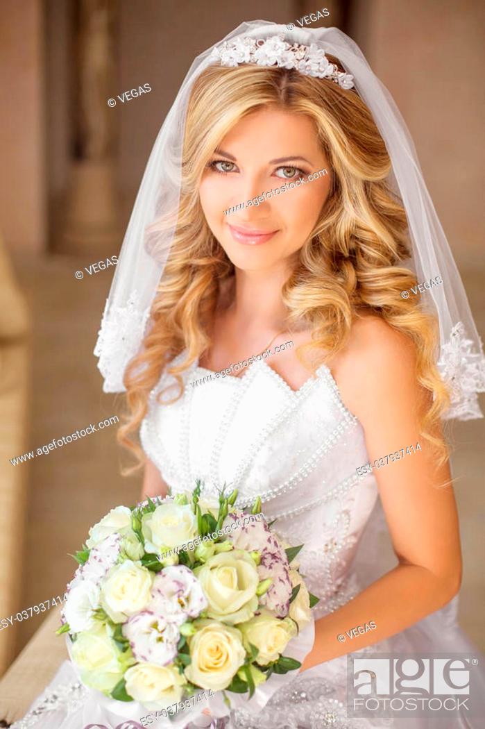 Portrait of a beautiful bride. Lace dress. Wedding hairstyle and makeup.  Bright lip color. Flowers on the side. Romantic atmosphere of the bride's  Stock Photo - Alamy