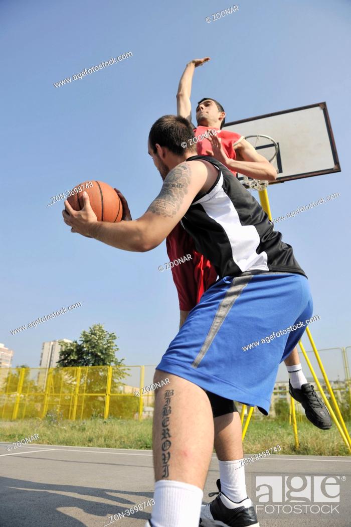 Stock Photo: streetball basketball game with two young player at early morning on city court.