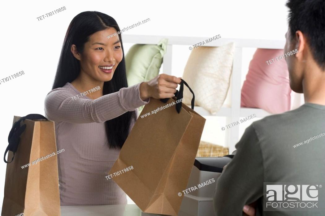 Stock Photo: Female sales person assisting customer.