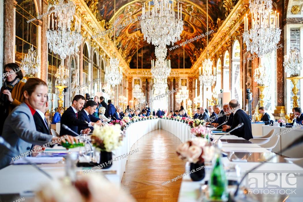 Stock Photo: 11 March 2022, France, Versailles: The heads of state and government of the European Union EU sit together at an informal two-day meeting at the Palace of.