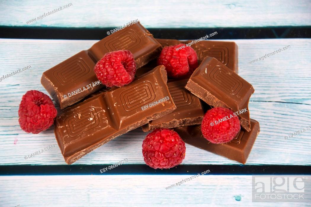 Stock Photo: some broken chocolate with raspberry.