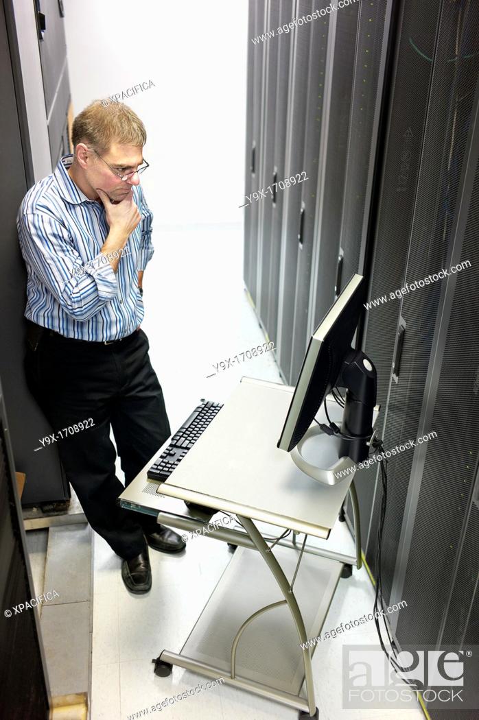 Stock Photo: A technician maintaining the server room.