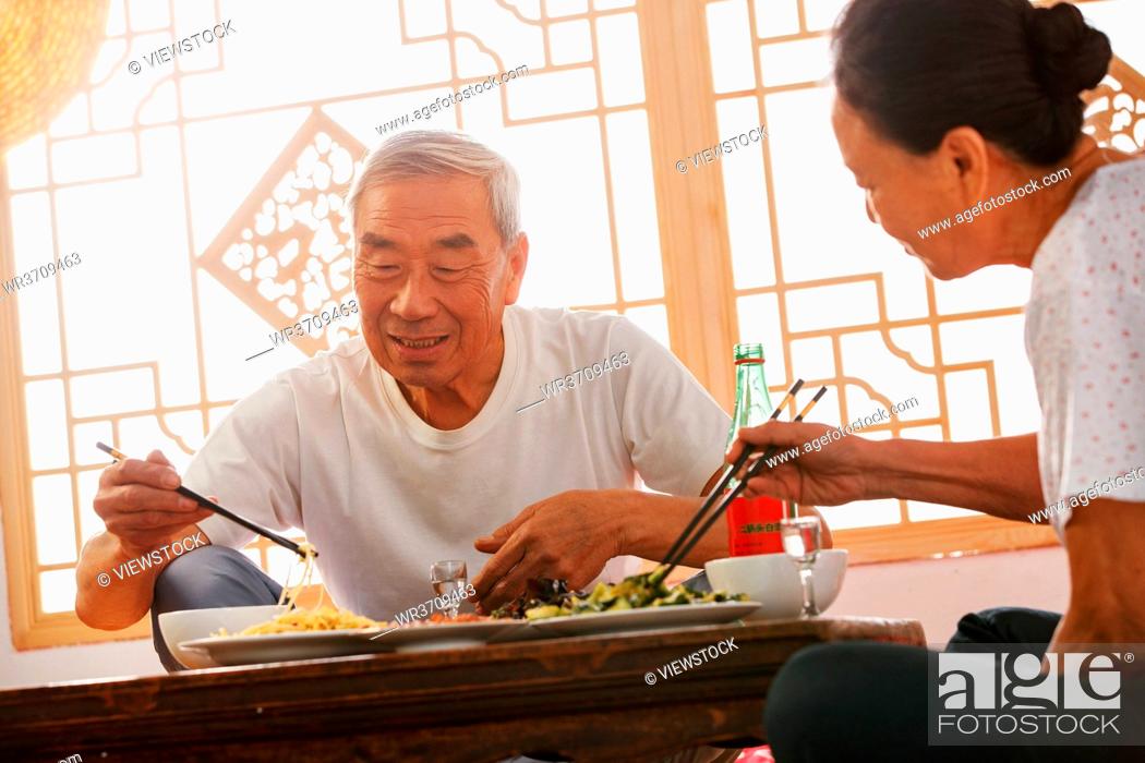 Stock Photo: Elderly couple at home for dinner.