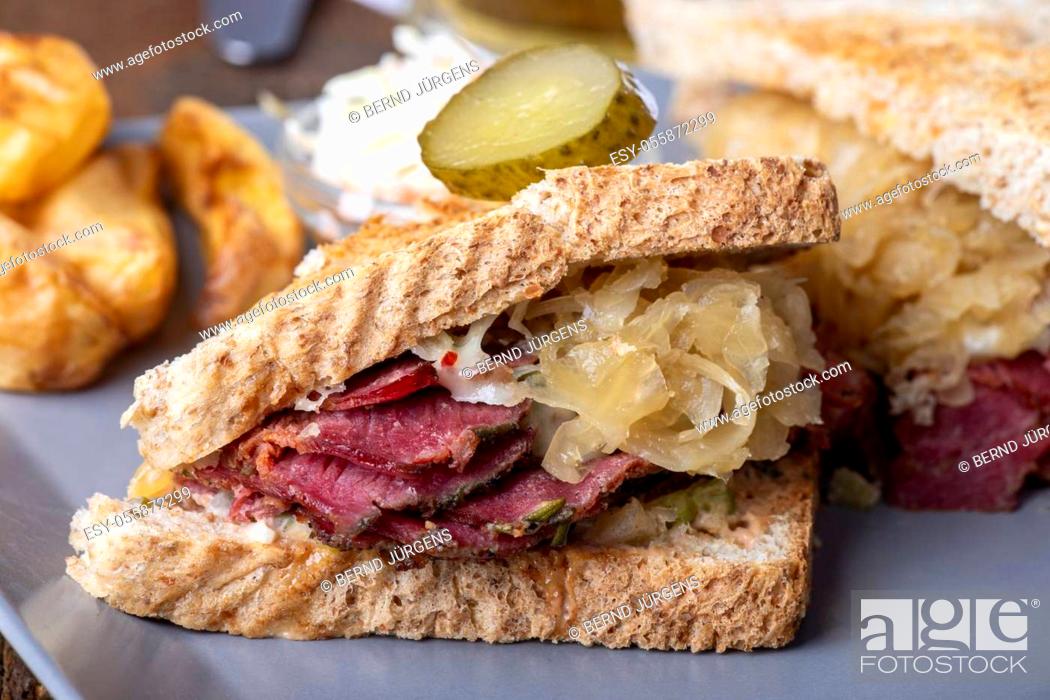 Stock Photo: reuben sandwich on a plate with fries.