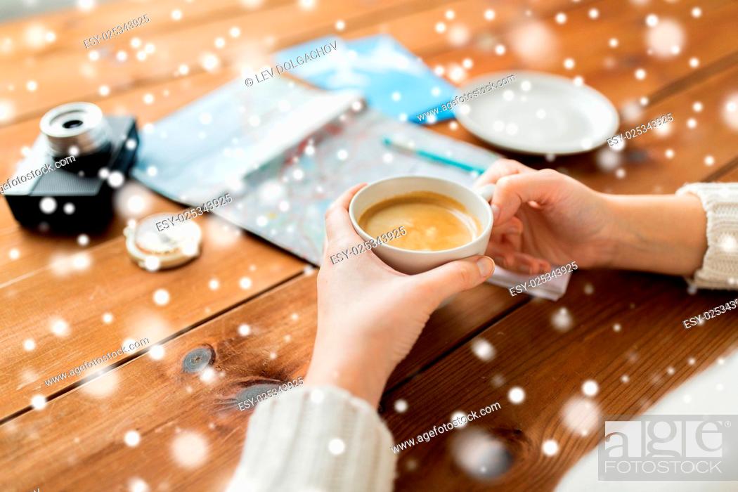Stock Photo: vacation, tourism, winter holidays and people concept - hands with coffee cup and travel stuff over snow.