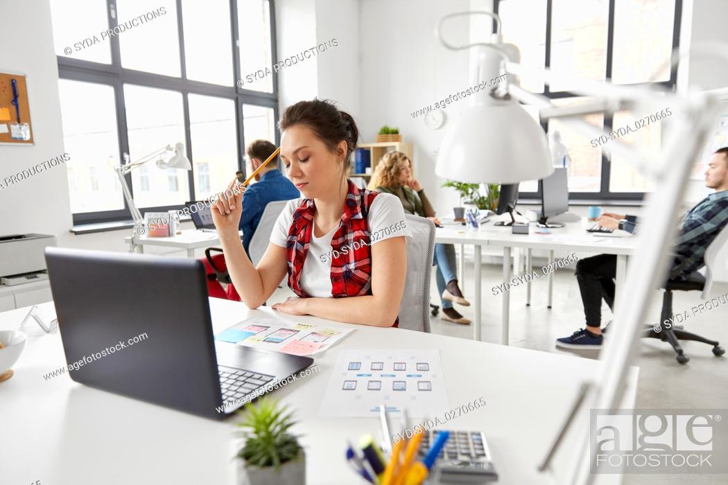 Stock Photo: creative woman working on user interface at office.