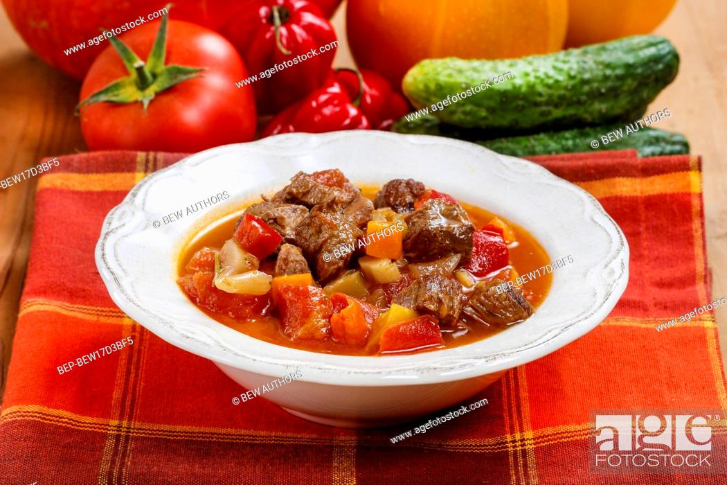 Stock Photo: Hungarian goulash with meat and fresh vegetables.