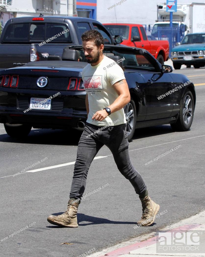 Stock Photo: Shia LaBeouf returning to his vehicle caught wearing a t-shirt that says, 'Every picture tells a story - don't it!' Featuring: Shia LaBeouf Where: Los Angeles.