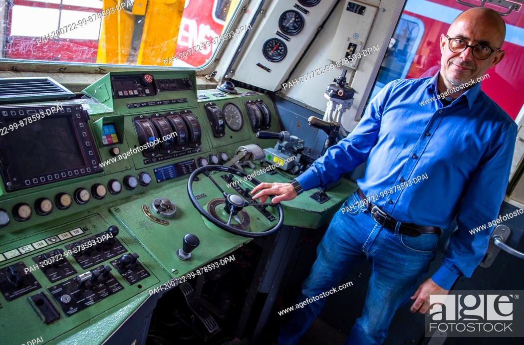 Stock Photo: 16 July 2020, Mecklenburg-Western Pomerania, Mukran: BPS managing director Ulrich Rudler is standing in the driver's cab of a class 181 electric locomotive.