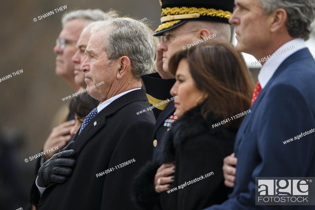 Stock Photo: Former US President George W Bush and members of the Bush family watch as a joint service honor guard carries the casket of former US President George H.