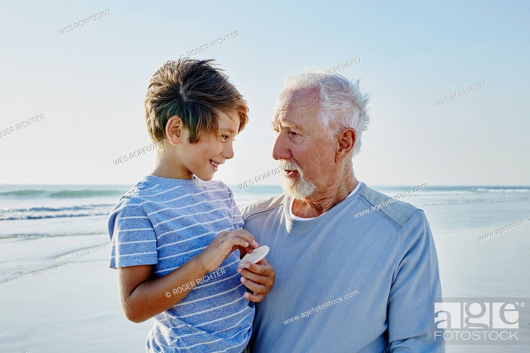 Stock Photo: Grandfather with grandson on the beach.