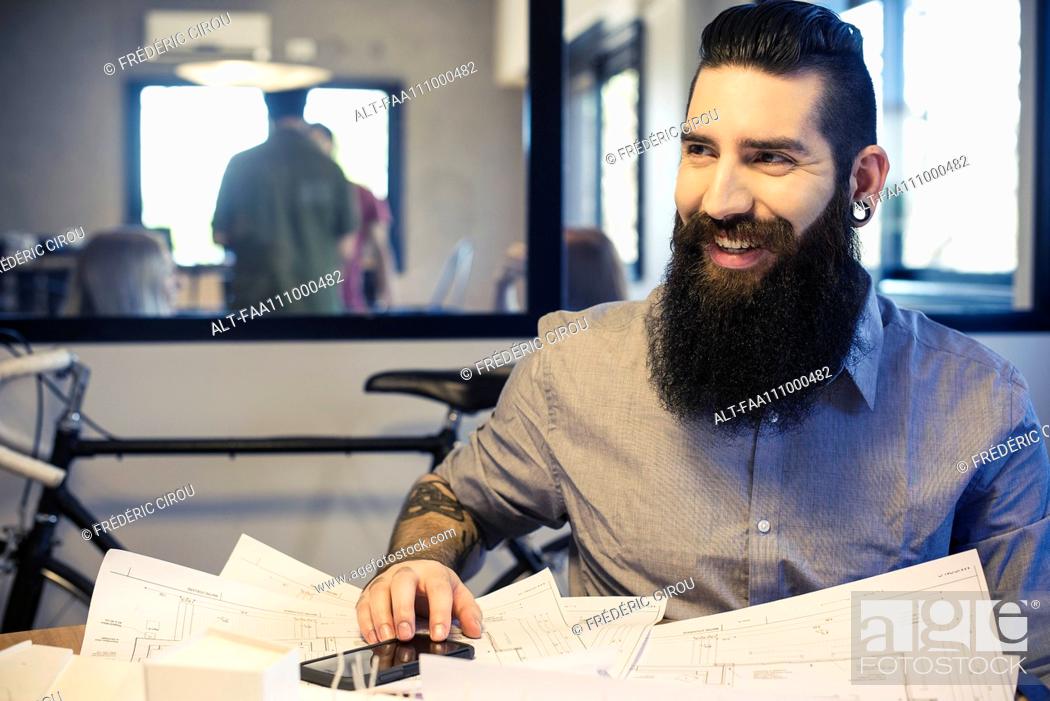 Stock Photo: Architect smiling in office.