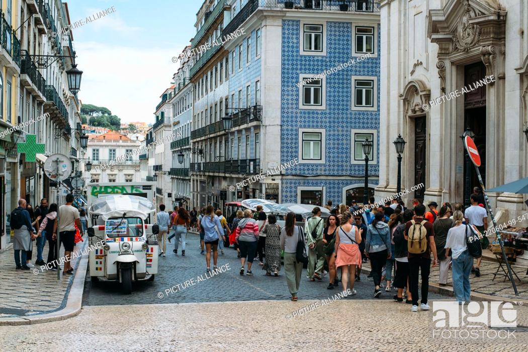 Stock Photo: 03 June 2022, Portugal, Lissabon: People stroll down the main Chiado street, Garrett Street, in downtown Lisbon. In the popular vacation destination of Portugal.