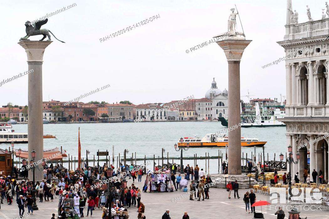 Stock Photo: 08 May 2019, Italy, Venedig: During the pre-opening period of the Venice 2019 Biennale, a boat can be seen on the water behind the St Mark and St Theodorus.