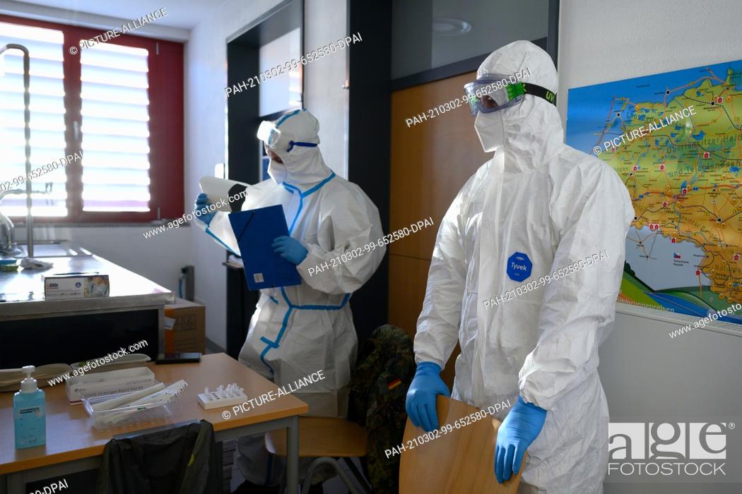 Stock Photo: 02 March 2021, Saxony, Radeberg: Health department employees prepare for a mass test for residents of the region in the gymnasium of the Radeberg vocational.