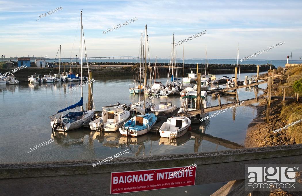 Stock Photo: Small harbour on the Atlantic coast ( near La Rochelle, France). In the background, the Ré island bridge. In the foreground.