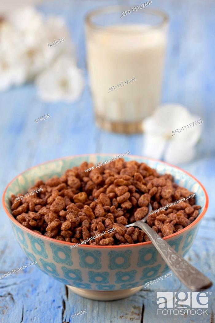 Stock Photo: Chocolate rice crispies and a glass of milk.