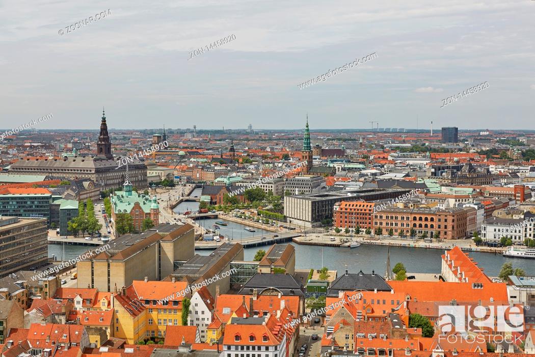 Stock Photo: COPENHAGEN, DENMARK - JUNE 28, 2017: Skyline of scandinavian city of Copenhagen in Denmark during a cloudy day.