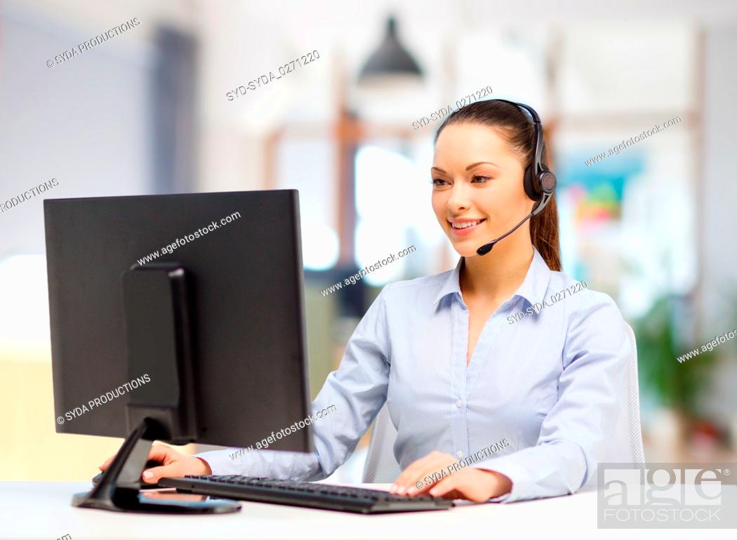 Stock Photo: helpline operator in headset working at office.