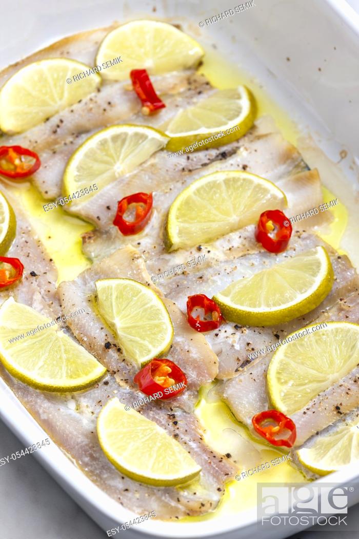Stock Photo: baked cod fish with lemon and chilli.