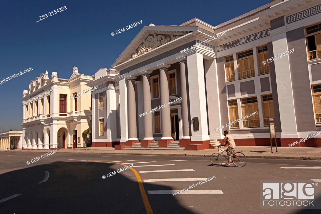 Stock Photo: Man riding a bike in front of the Colegio San Lorenzo and Thomas Terry Theater, Cienfuegos, Cienfuegos Province, Cuba, Central America.