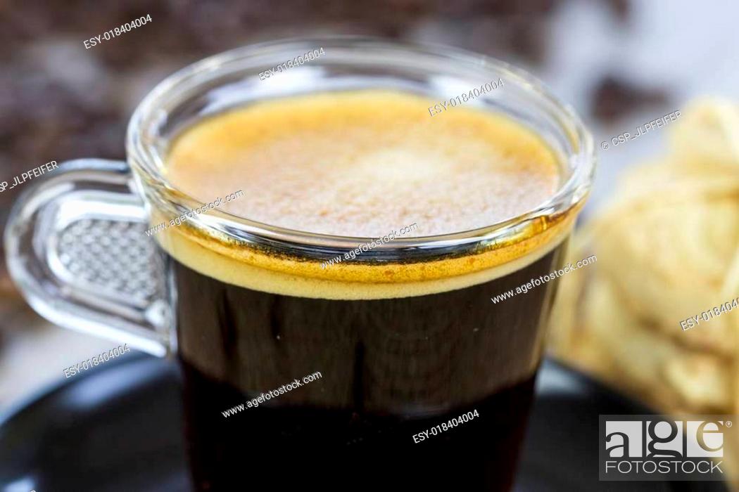 Stock Photo: Strong mug of espresso coffee with coffee beans.