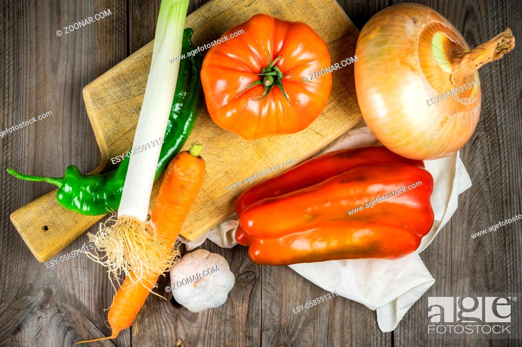 Stock Photo: Fresh vegetables ready for cooking shot on rustic wooden table .