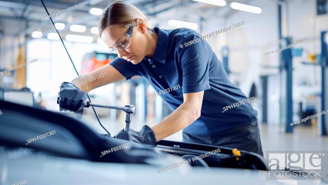 Stock Photo: Mechanic working on car.