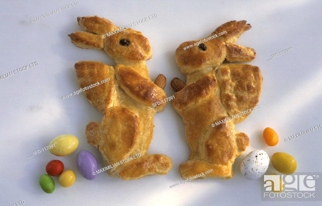 Stock Photo: Two Easter bunnies made from dough with sugar eggs.