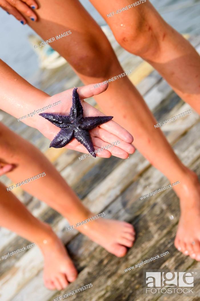 Stock Photo: Starfish on childs hand.