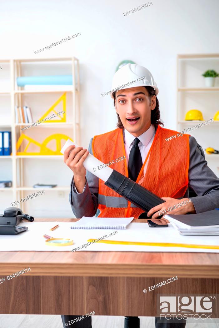 Stock Photo: The young male architect working in the office.