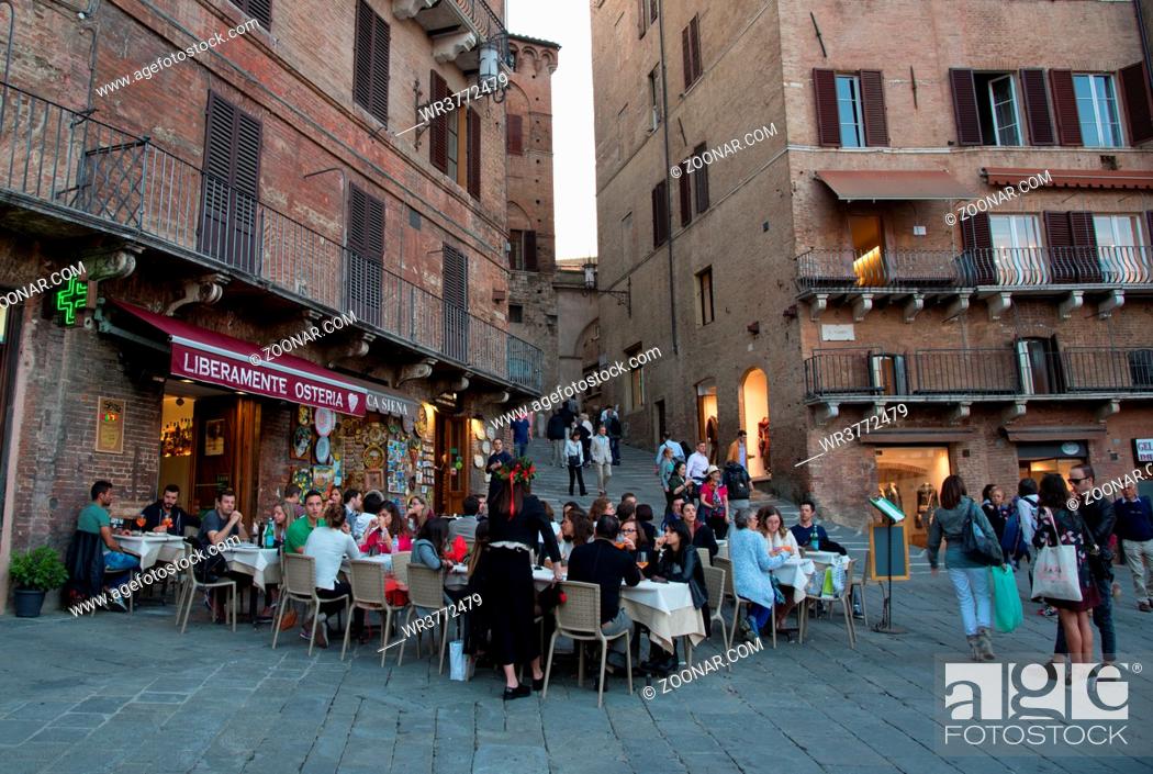 Stock Photo: Sienna, Italy, October 2 2017: People relaxing at the coffee shops in the streets of Siena historic town Italy, Europe.