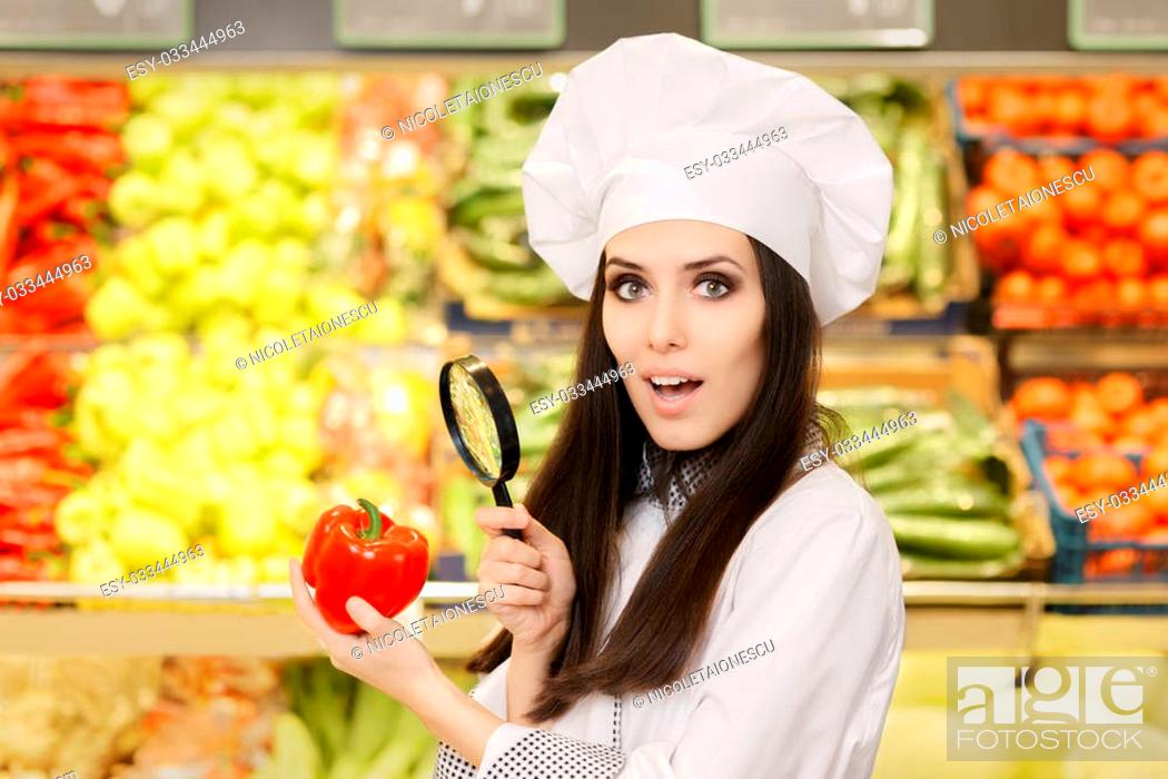 Stock Photo: Portrait of a young female cook in a grocery store checking for best quality ingredients.