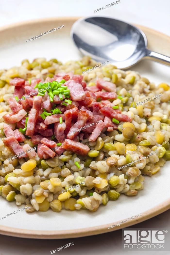 Stock Photo: porridge of legumes with fried bacon and chive.