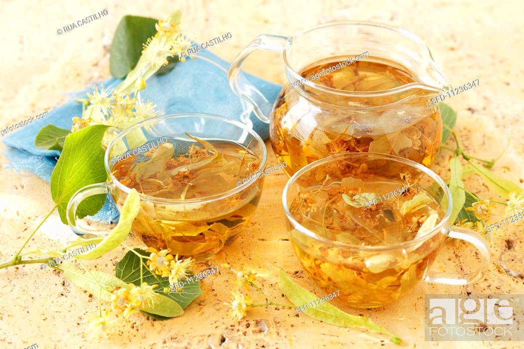 Stock Photo: Limeflower tea in a glass jug and glass teacups.