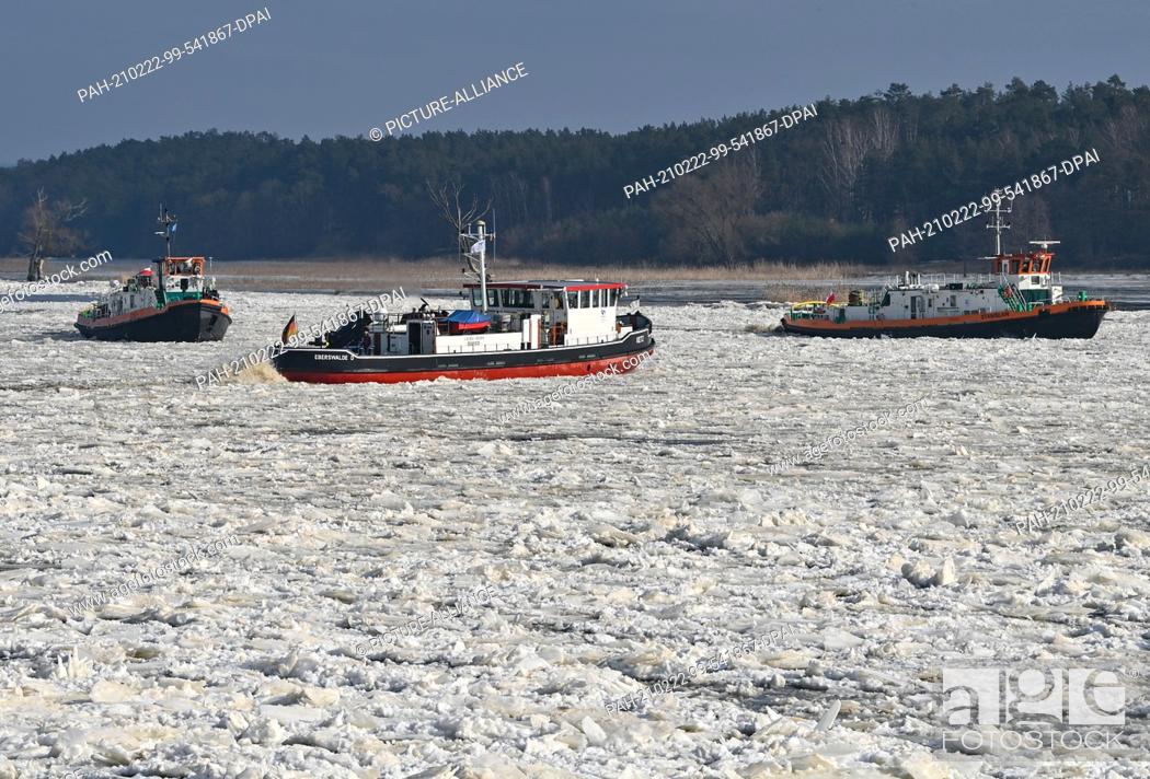 Stock Photo: 18 February 2021, Brandenburg, Schwedt: A German (M) and two Polish icebreakers navigate on the German-Polish border river Oder.