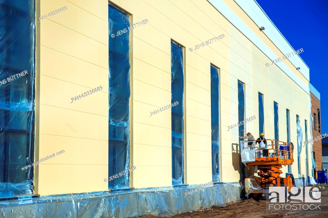 Stock Photo: Construction workers work on a new building for the development centre at the pizza plant of food manufacturer Dr. Oetker in Wittenburg, Germany.