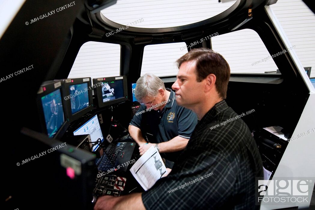 Stock Photo: NASA astronauts Greg Chamitoff (foreground), STS-134 mission specialist; and Greg H. Johnson, pilot, participate in an exercise in the systems engineering.