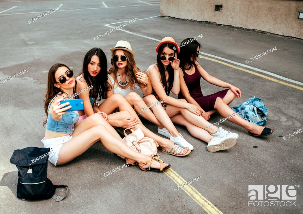 Stock Photo: Five beautiful young girls relaxing in the city.