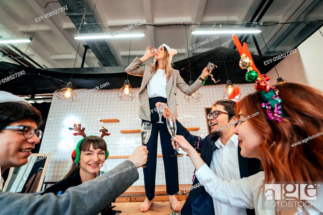 Stock Photo: Happy colleagues in office celebrate special event together, smiling diverse work team have fun laugh. Friendship concept.