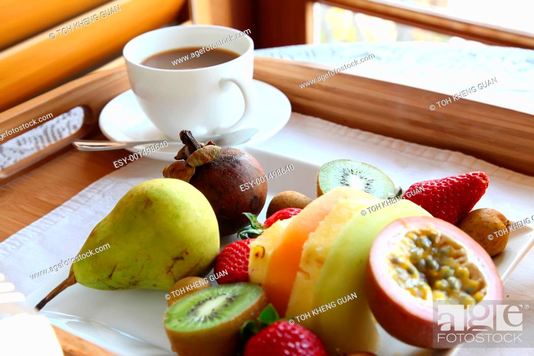 Photo de stock: Tropical fruits tray breakfast.