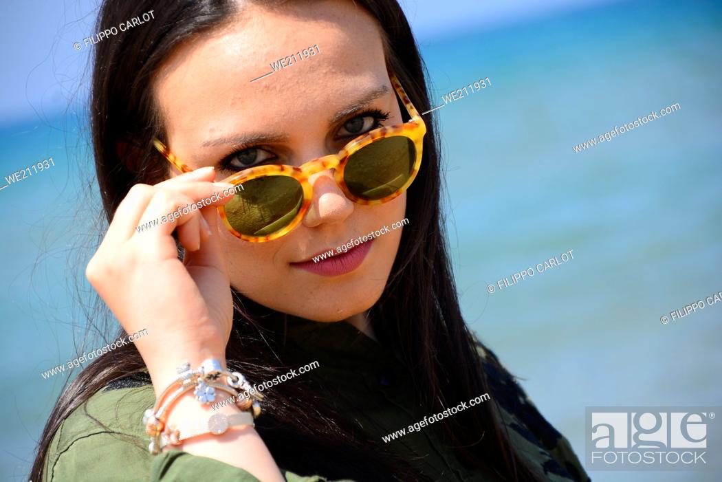Stock Photo: Cute Chubby teenager poses on the beach in a sunny day.