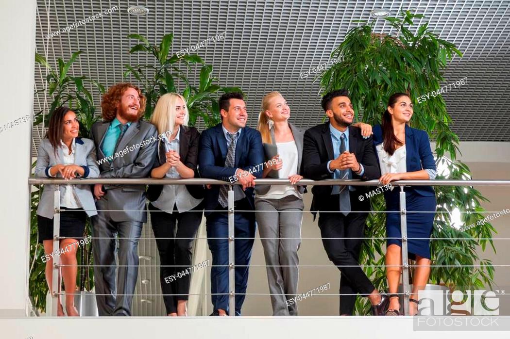 Stock Photo: Young Business Man And Woman Group Stand Looking Up Happy Smiling Wearing Suits, Businesspeople Colleagues Team Modern Office Space.