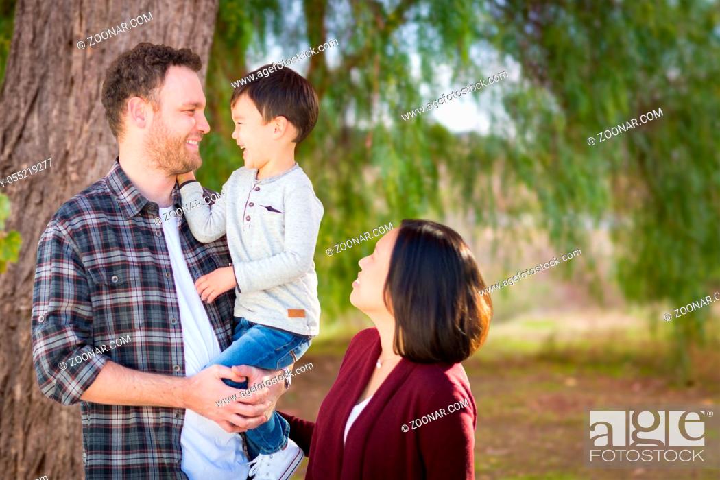 Stock Photo: Young Mixed Race Caucasian and Chinese Family Portrait Outdoors.