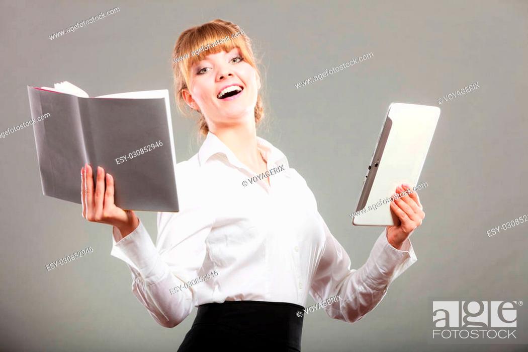 Stock Photo: Happy woman learning with ebook reader and book. Choice between modern educational technology and traditional way method.