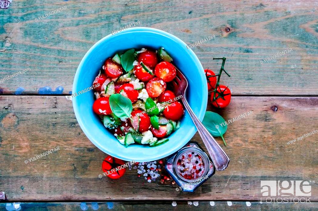 Stock Photo: Colorful summer vegetables and feta cheese salad in bowl on grunge wooden background. Weight loss clean eating, vegan, vegetarian, healthy, dieting food concept.